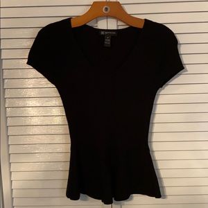 V-neck sweater, flared out at waistline.